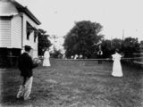 Picture relating to Dutton Park - titled 'Poulsen family playing tennis in the backyard of their Gladstone Road residence, Brisbane, Queensland, ca. 1910'