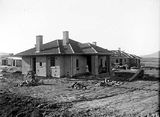 Picture relating to Forrest - titled 'Oakley and Parkes style houses under construction, Blandfordia (now Forrest).'
