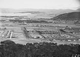 Picture relating to Cotter Dam - titled 'Braddon and Civic Centre from Mt Ainslie Upstream, Cotter Dam from the Dam wall Braddon from Mt. Ainslie, City Hill on left Civic Centre, Gorman House, Ainslie Hotel in front.'