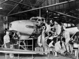 Picture relating to Archerfield - titled 'Aircraft mechanics working on an Avro Anson Mk1 plane, Archerfield, ca. 1942'